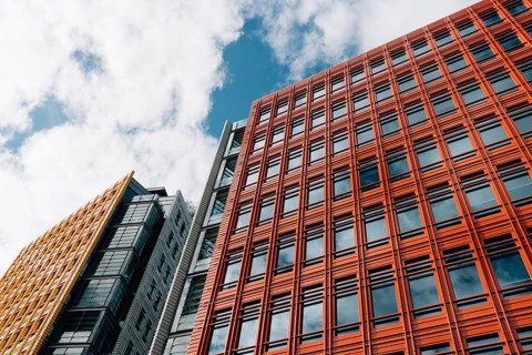 London, UK, August 27, 2023: Low angle view of modern and colorful apartment and office buildings