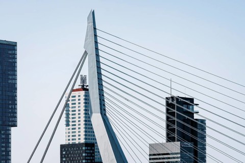 Rotterdam, Netherlands, May 8, 2022: Port of Rotterdam skyscraper and Erasmusbrug bridge against