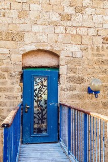 Doors bound by metal bars. Sunset. Old Yaffo - one of the most ancient cities of the world. Warm