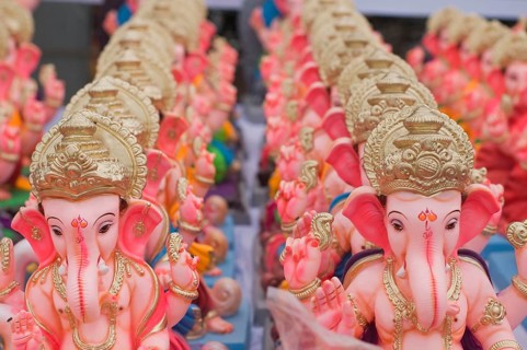 Several small idols of lord Ganesha line up for sale Pune Maharashtra India Asia