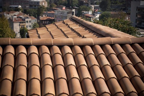 Tiles on old castle roof, architecture background. Brown roof tiles