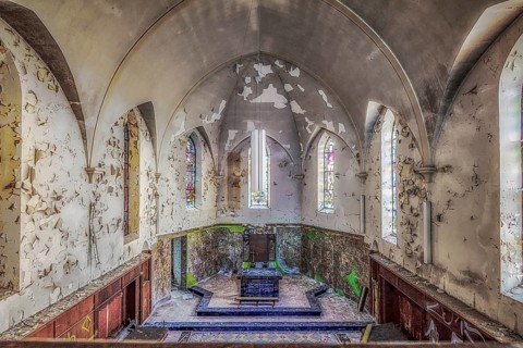 Church interior with colourfully decorated stained glass windows and an old altar, Agnus Dei, Lost
