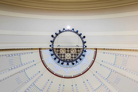 View to the ceiling of a building with modern chandelier and geometric patterns, Prague, Railway