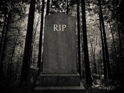 Spooky RIP Gravestone In A Dark Forest Setting