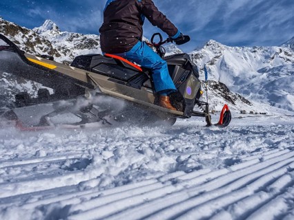Snowmobile on a trail in the Italian alps