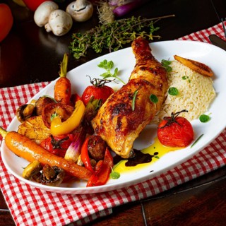 Rustic fried chicken legs with assorted vegetables and rice