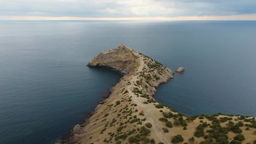 Autumn morning and a mountain landscape by the sea, a promontory protruding into the water
