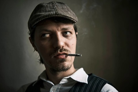 Young guy smoking cigarette, blows smoke, dressed in a retro style, in a beret, cinematic shot, big