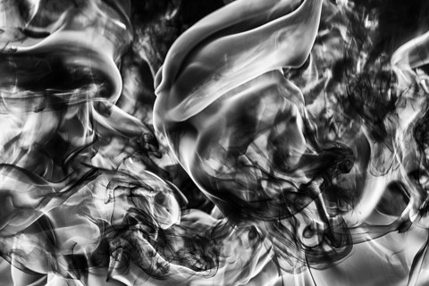 Abstract plume of natural black smoke and white huge flame of strong fire, motion blur from fire,