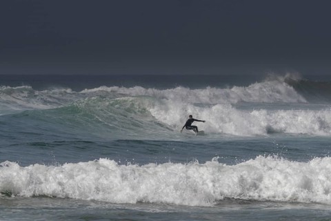 Sidi Ifni, Morocco, 17 March, 2024: man surfing a large wave off the coast of southern Morocco in