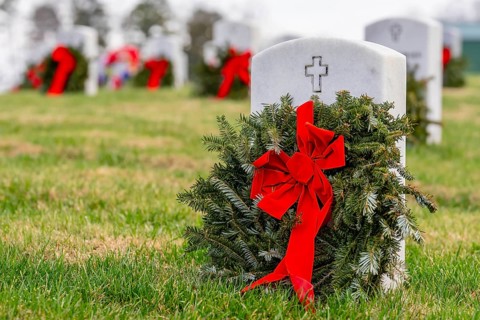 Atop a hill, a veterans cemetery with white headstones and the American flag evokes deep honour,