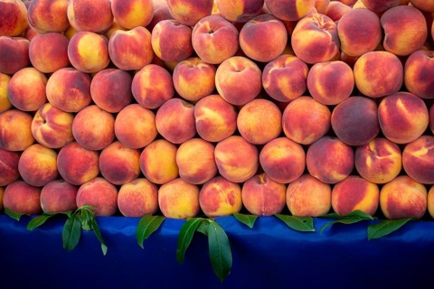 Background of peaches. Ripe and juicy peaches are sold at the farmers