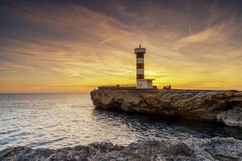A view of the lighthouse at Colonia Sant Jordi in Mallorca at sunset