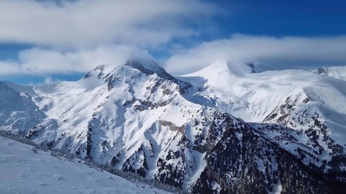 Beautiful Pirin mountains peaks covered with snow. Winter view at Bansko ski resort in Bulgaria