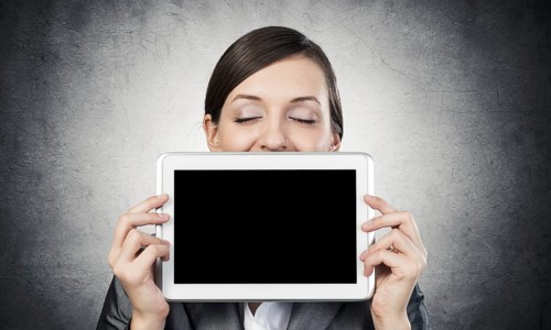 Businesswoman holding tablet computer with blank screen. Beautiful woman with closed eyes showing