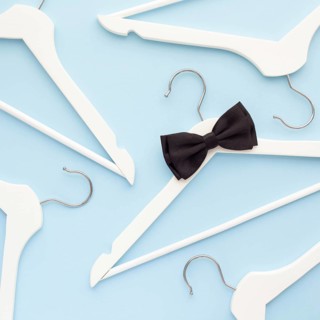 Creative top view flat lay white wooden hangers isolated pastel blue background with copy space