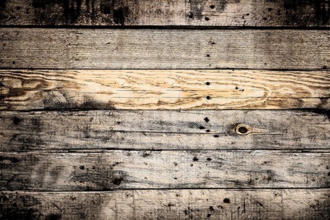 Horizontal wooden planks forming a textured background, weathered and showing knots and grain