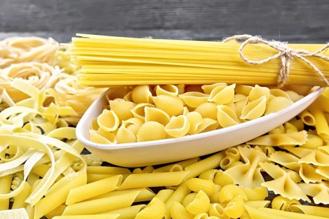 Pasta seashells and spaghetti in a bowl, pipe rigate, tagliatelle, fusilli, penne, farfalle,