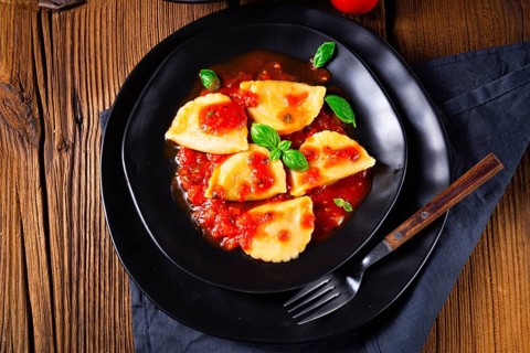 Ravioli alla genovese with basil and tomato sauce