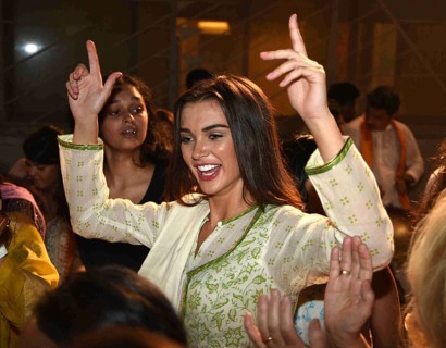 Bollywood actor Amy Jackson participates in a procession for the immersion of an idol Hindu god