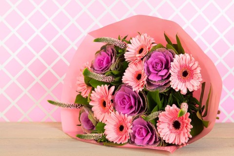 Colorful wrapped pink and purple bouquet in interior