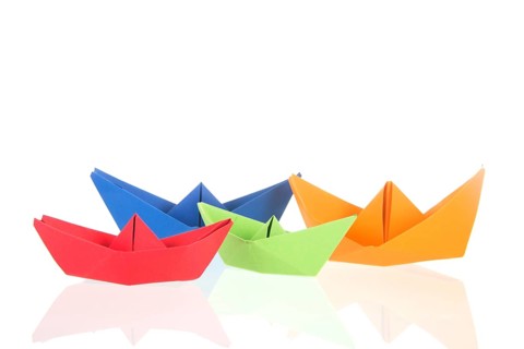 Folded boats and stack paper isolated over white background