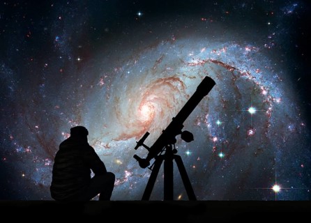 Man with telescope looking at the stars. Stellar Nursery NGC 1672. Spiral galaxy in the