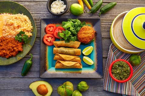 Mexican flautas rolled tacos with salsa and Mexico food ingredients