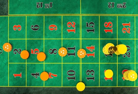 Roulette table chips in a casino. Closed up of casino roulette gambling table game. Yellow and