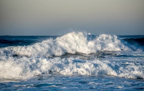 Dangerous wavy ocean with wind waves crashing during tropical storm