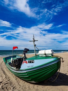 Fishing boat on Stenbjerg beach near Vorupor in Jutland, Denmark, Europe