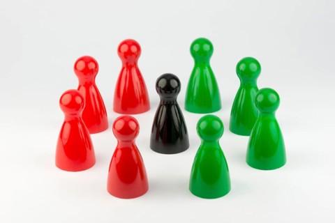 Conceptual game pawns that depict the concept different