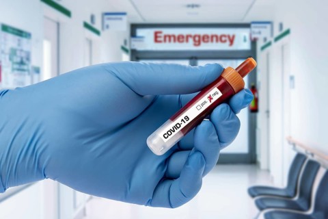 Covid 19 person holding a test tube with coronavirus, in the lab