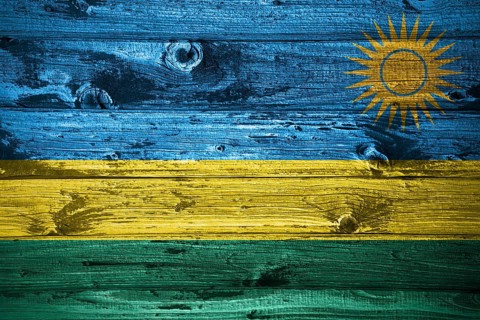 Rwanda flag on wooden planks background wood flag