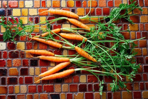 Mini Carrot vegetables on a tiles table background
