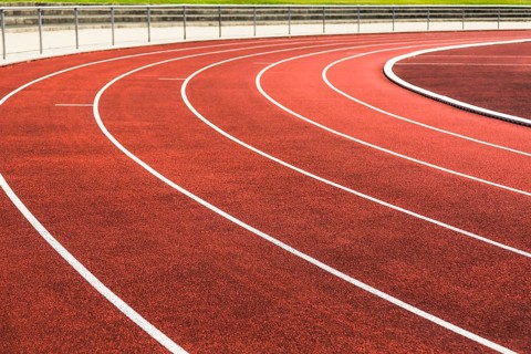 Cinder track in detail in a stadium in summer