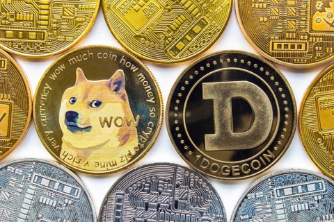 Calgary, Alberta, Canada. May 22, 2021. A couple of Dogecoin with several crypto currency coins
