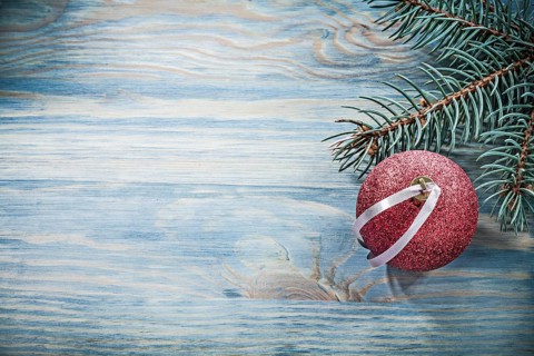 Fir branch red Christmas ball on wooden board celebrations concept