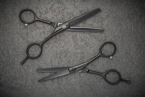 Barber Professional Tools. Haircut Fashion. Pair Of Professional Haircutting Scissors On Black