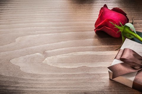 Packed present with brown ribbon red rose holiday concept