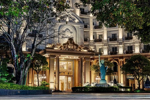 Close-up of a grand hotel entrance with classical columns and illuminated at night, nigtht, city,