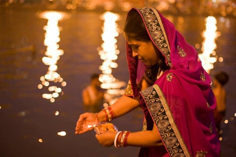 Woman offering oil lamp to godavari river, Nasik, maharashtra, india, asia