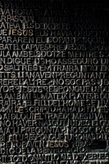 Detail with word Jesus on the bronze door of Passion facade of Sagrada Familia in Barcelona. The