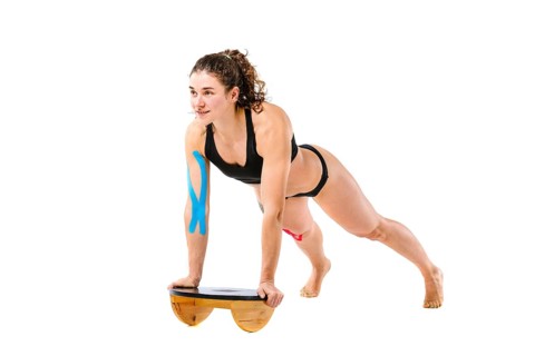 Kinesio tape girl, exercise push ups. Attractive Young sport Woman Doing Push Up Exercise in full