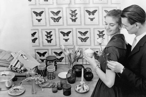 In the 1950s. A young with the typical 1950s designed objects, household appliencies and details on