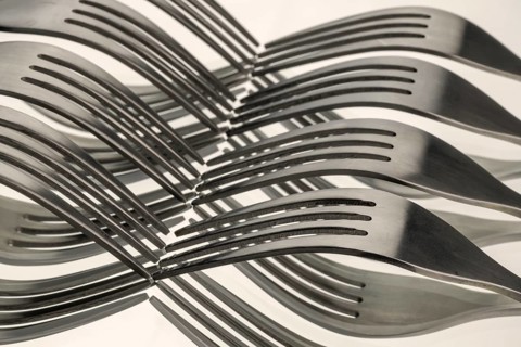 Abstract artistic picture of wavy forks, which form a wave pattern by means of mirroring