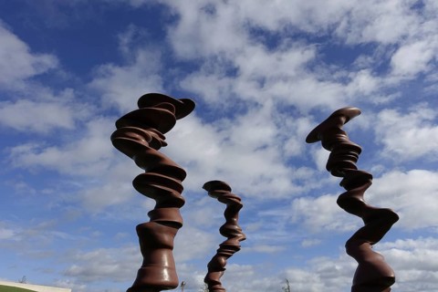 Würth Museum 2, Abstract wooden sculptures tower up into the partly cloudy sky, Carmen Würth Forum,