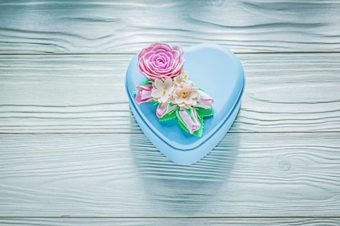 Heart-shaped present box on wooden board holidays concept
