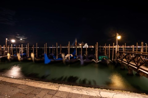 Venetian gondolas, boat dock at St Mark's Square, church of San Giorgio Maggiore in the background,