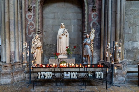 Dijon, France, 14 September, 2022: votive candles and altar in a side chapel of the Notre Dame of